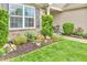 Manicured front yard with lush landscaping, greenery, flowers, and a well-maintained lawn at 10731 Jimmy Lake Dr, Indianapolis, IN 46239