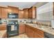 Efficient kitchen layout with wooden cabinets, laminate countertops, and modern appliances at 10731 Jimmy Lake Dr, Indianapolis, IN 46239
