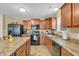 Functional kitchen featuring wood cabinets, laminate countertops, and modern appliances at 10731 Jimmy Lake Dr, Indianapolis, IN 46239