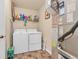 A laundry room with white washer and dryer and tile flooring at 10731 Jimmy Lake Dr, Indianapolis, IN 46239