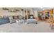 A living room with plush carpet, fireplace, open kitchen, and neutral tones at 10731 Jimmy Lake Dr, Indianapolis, IN 46239