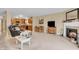A living room with a fireplace, dining area, and open access to the kitchen at 10731 Jimmy Lake Dr, Indianapolis, IN 46239