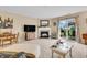 Bright living area featuring a cozy fireplace and sliding glass doors leading to the patio at 10731 Jimmy Lake Dr, Indianapolis, IN 46239