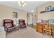 Comfortable living room featuring classic armchairs, a wooden desk, and neutral carpeting at 10731 Jimmy Lake Dr, Indianapolis, IN 46239
