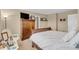 A bedroom with a dark wooden dresser, decorative items and a comfortable bed at 10731 Jimmy Lake Dr, Indianapolis, IN 46239