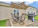 Outdoor patio featuring a table with umbrella, chairs, and a grill, perfect for outdoor dining and entertaining at 10731 Jimmy Lake Dr, Indianapolis, IN 46239