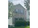 Charming two-story home with light brick, dark shutters and well-manicured landscaping at 10746 Raven Ct, Fishers, IN 46038