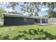 View of the home's back exterior, featuring a deck and sliding glass door at 1082 Galaxie Dr, Greenwood, IN 46142