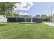 View of the home's back exterior, featuring a deck, sliding glass door, and lush green lawn at 1082 Galaxie Dr, Greenwood, IN 46142