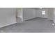 Basement features neutral gray carpet, multiple access points to other rooms, and a small window at 1082 Galaxie Dr, Greenwood, IN 46142