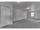 Carpeted basement offers a closet, a small window, neutral paint, and access to other rooms at 1082 Galaxie Dr, Greenwood, IN 46142