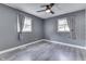 Bedroom featuring light gray walls, hardwood floors, ceiling fan, and natural light at 1082 Galaxie Dr, Greenwood, IN 46142