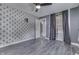 Bedroom with a patterned wallpaper, ceiling fan, hardwood floors, and open closet space at 1082 Galaxie Dr, Greenwood, IN 46142
