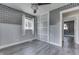 Bedroom with light gray walls, hardwood floors, and a modern sliding door closet at 1082 Galaxie Dr, Greenwood, IN 46142