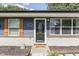 Charming home facade showcasing a glass front door, blue siding, and decorative shutters at 1082 Galaxie Dr, Greenwood, IN 46142