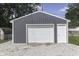 A new garage with modern paneled doors, gray siding, and a white trim at 1082 Galaxie Dr, Greenwood, IN 46142