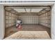 Spacious garage interior featuring a motorcycle, wood flooring, and an open ceiling at 1082 Galaxie Dr, Greenwood, IN 46142