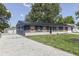 Attractive home with blue siding, decorative shutters, a gravel driveway, and a lush lawn at 1082 Galaxie Dr, Greenwood, IN 46142
