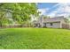 Spacious backyard featuring lush greenery, a wooden fence, and the rear exterior of the home at 1104 Briarwood Dr, Brownsburg, IN 46112