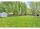 Spacious backyard with a wooden fence, shed, and grill at 1104 Briarwood Dr, Brownsburg, IN 46112