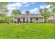 View of the home's backyard with a well-maintained lawn, patio, and exterior of the house at 1104 Briarwood Dr, Brownsburg, IN 46112