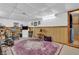 This basement has wood paneling, a patterned rug, workout equipment, and storage at 1104 Briarwood Dr, Brownsburg, IN 46112