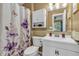 Charming bathroom with floral accents, white vanity, and ample lighting at 1104 Briarwood Dr, Brownsburg, IN 46112