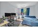 This bedroom features a blue bed set and a desk setup with dual monitors at 1104 Briarwood Dr, Brownsburg, IN 46112