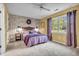 Cozy bedroom features plush carpeting, decorative wall, and natural lighting from window at 1104 Briarwood Dr, Brownsburg, IN 46112