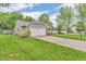 This exterior view shows a home with green grass, an attached garage, and a gray roof at 1104 Briarwood Dr, Brownsburg, IN 46112