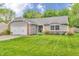 Charming home featuring a brick and gray exterior, a well-manicured lawn, and an attached garage at 1104 Briarwood Dr, Brownsburg, IN 46112