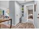 Neutral-toned hallway with view of the entry to a bedroom, white trim, and decorative HOME sign at 1104 Briarwood Dr, Brownsburg, IN 46112
