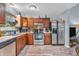 Modern kitchen with stainless steel appliances and wood cabinets and laminate flooring at 1104 Briarwood Dr, Brownsburg, IN 46112