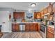 Spacious kitchen features stainless appliances, wood cabinets, and durable, modern flooring at 1104 Briarwood Dr, Brownsburg, IN 46112
