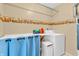 This is a bright laundry room with floral wallpaper and plenty of counter space at 1104 Briarwood Dr, Brownsburg, IN 46112