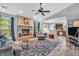 Open-concept living area showcasing a brick fireplace, hardwood floors, and modern furnishings at 1104 Briarwood Dr, Brownsburg, IN 46112