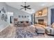 Bright living room with a brick fireplace, hardwood floors, and stylish decor at 1104 Briarwood Dr, Brownsburg, IN 46112