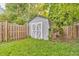 Fenced backyard featuring a storage shed for storing tools and lawn equipment at 1104 Briarwood Dr, Brownsburg, IN 46112