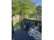 Backyard deck with leafy trees, natural light, and black metal rails overlooking the lawn at 1128 S Pennsylvania St, Indianapolis, IN 46225