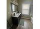 Bathroom with vanity, sink, and tub-shower combination at 1128 S Pennsylvania St, Indianapolis, IN 46225