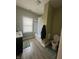 Bathroom with single sink vanity, toilet, and tub/shower combo with white tile surround at 1128 S Pennsylvania St, Indianapolis, IN 46225