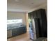 Well-appointed kitchen with stainless steel appliances, dark cabinets, and lots of natural light from a window at 1128 S Pennsylvania St, Indianapolis, IN 46225