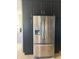 Close up of stainless steel refrigerator with dark cabinets and lots of space for food and storage at 1128 S Pennsylvania St, Indianapolis, IN 46225
