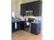 Galley kitchen features stainless steel oven, dark cabinets, and laminate countertops at 1128 S Pennsylvania St, Indianapolis, IN 46225