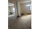 Inviting living area with carpet flooring and access to a hallway with hardwood flooring and lots of light at 1128 S Pennsylvania St, Indianapolis, IN 46225