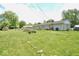 Extensive backyard with a fire pit, mature trees, and a storage shed at 12144 Trolley Rd, Indianapolis, IN 46236