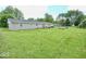 Large, well-maintained backyard with mature trees and a patio area at 12144 Trolley Rd, Indianapolis, IN 46236
