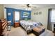 Comfortable bedroom features a ceiling fan and an upholstered ottoman at the foot of the bed at 12144 Trolley Rd, Indianapolis, IN 46236