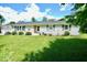 Charming single-story home with well-maintained lawn, trimmed bushes, and pleasant curb appeal at 12144 Trolley Rd, Indianapolis, IN 46236