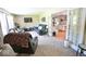 Comfortable living room featuring cozy seating, a TV, and an open view into the kitchen through french doors at 12144 Trolley Rd, Indianapolis, IN 46236